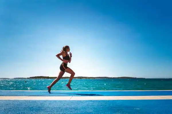 Woman running showing strong leg muscle Malmesbury
